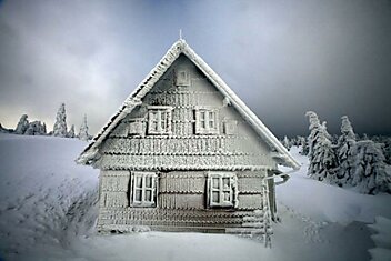 Дом, покрытый снегом и льдом.