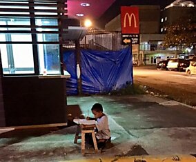 Этот малыш делал уроки прямо на улице при свете витрины! Всего одно фото перевернуло его жизнь.
